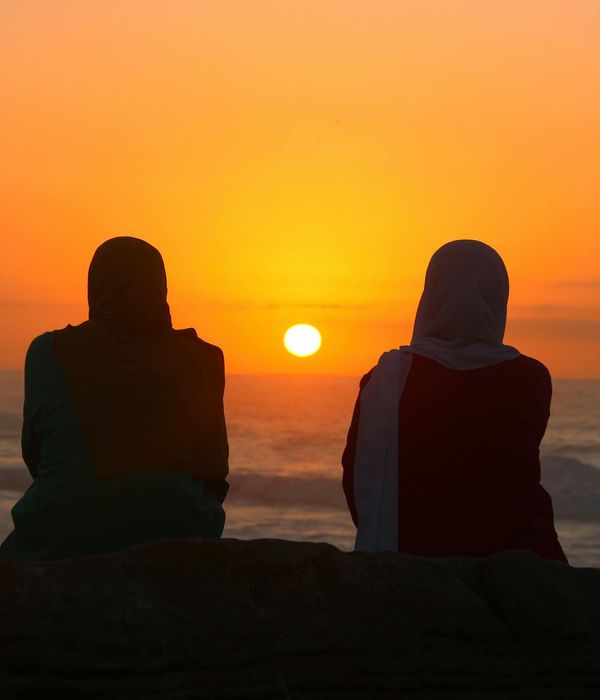 A silhouette of a person meditating against a calm backdrop.